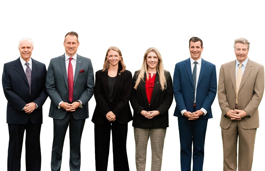 A group of six professionally dressed individuals stands together against a black background, showcasing a range of suits and hairstyles