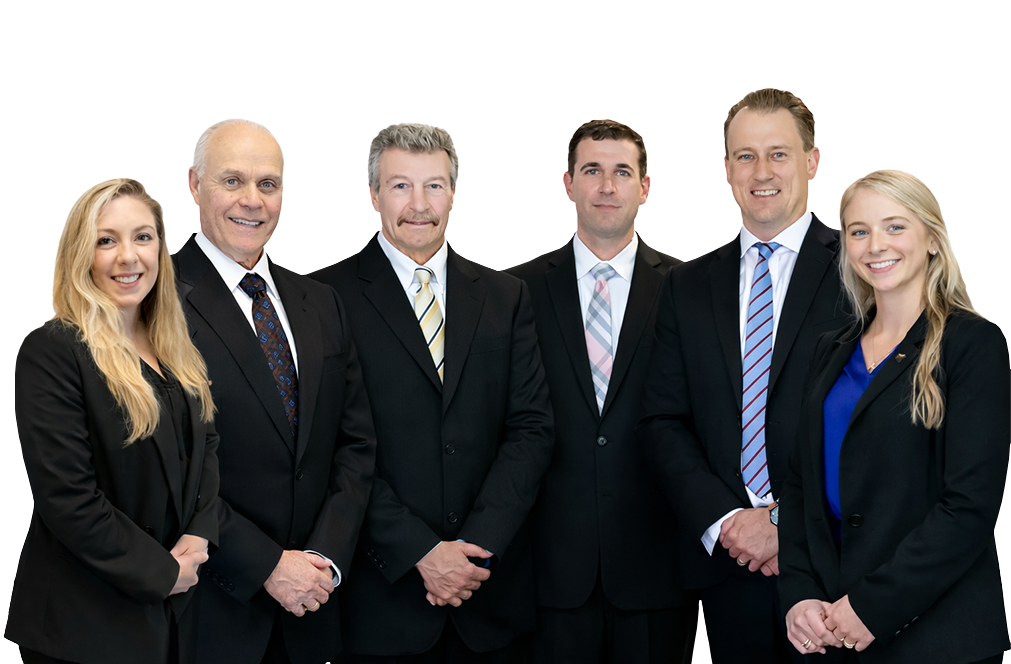 A group of six professionally dressed individuals stands together against a black background, showcasing a range of suits and hairstyles